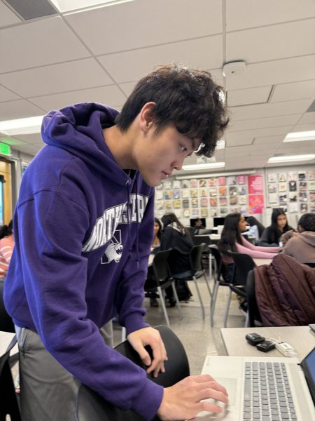 Senior Alan Tai looks down at a computer during an El Estoque work session. Tai is the California High School Journalist of the Year and now moves onto the national competition. Photo: Jami Lim with permission